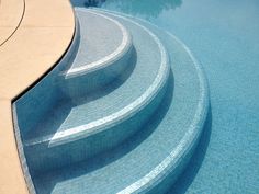 an empty swimming pool with steps leading up to it