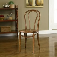 a wooden chair sitting on top of a hard wood floor