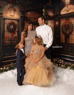 a man and two children standing in front of a christmas display