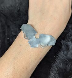 A semi-adjustable cuff Bracelet inspired by armor bracers with a SciFi aesthetic this bracelet comes in one size and will fit a wrist up to 7 in in diameter. Please reach out for more sizing options. Medieval Adjustable Bangle Cuff Bracelet, Adjustable Medieval Bangle Cuff Bracelet, Scifi Aesthetic, Headpiece Jewelry, Hair Adornments, Pendant Bracelet, Cuff Bracelet, Body Jewelry, Necklaces Bracelets