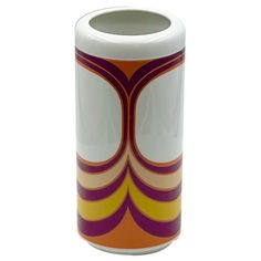 a white vase with an orange and purple design on it