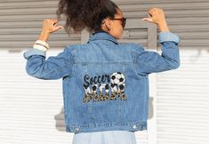 Elevate your game-day style with our Soccer Mom Denim Jacket, the perfect blend of comfort and chic for any dedicated mom. Designed with both function and flair in mind, this jacket is a game-changer for those bustling soccer Saturdays. Whether you're cheering from the sidelines or enjoying a casual outing, it makes an ideal Mother's Day gift that shows off your stylish spirit and endless love. Embrace the joy of motherhood and sporty elegance with this must-have addition to your wardrobe! 🌟👖 Casual Game Day Outerwear With Letter Print, Casual Letter Print Outerwear For Game Day, Casual Outerwear With Letter Print For Game Day, Casual Fall Outerwear For Game Day, Fall Letter Print Medium Wash Outerwear, Soccer Coach, Mom Denim, From The Sidelines, Soccer Game