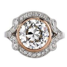 an antique style diamond ring with two tone gold accents