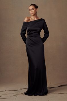 Exude elegance.The AVERY Long Sleeve Maxi Dress features an asymmetrical drop shoulder neckline, adding modern sophistication. With long sleeves for coverage and grace, it boasts side gathered waist detailing for a touch of femininity. Lined for comfort, this dress ensures you look and feel your best for any elegant occasion. Off The Shoulder Black Dress Long Sleeve, Black Tie Event Dresses Long Sleeve, Elegant Black Dress With Sleeves, Black Long Dresses Elegant, Black Dress With Sleeves Formal, Dress For Christmas Wedding Guest, Black Tie Wedding Guest Dress With Sleeves, Black Long Sleeve Satin Dress, One Shoulder Dress Long Sleeve