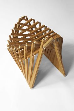 a stack of wooden chairs sitting on top of a white floor next to each other