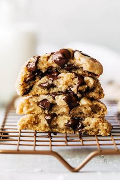 chocolate chip cookies cooling on a wire rack with a glass of milk in the background