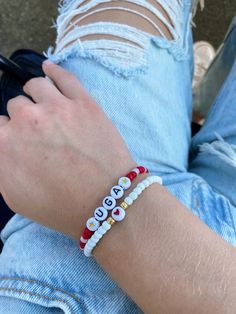 Show your school pride and complete your game day outfit with a custom red and white beaded bracelet for the University of Georgia! Georgia Bulldogs Clay Bead Bracelet, Georgia Game Outfits, Georgia Bracelets, Game Day Jewelry, White Beaded Bracelet, Go Dawgs, Bracelets Tutorial, Game Day Outfit, Game Day Hair