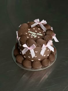 a heart shaped chocolate cake with pink bows