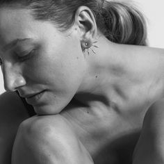 black and white photograph of a woman with her head resting on her hands behind her back