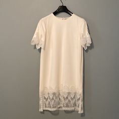 This Burberry Dress Is Crafted From Embroidered Tulle And A Macrame Lace Motif At The Back. This Dress Features Loose- Fit Design, Scalloped Sleeves, Short Sleeves, Concealed Side Zip And Back Keyhole. Made In Italy. Although This Dress Is Us Size 8 But It Runs Small So It Better With Ladies In Size 6 Elegant Mini Dress With Cutwork Hem, Elegant Mini Dress With Cutwork Hem For Daywear, Elegant Daytime Mini Dress With Cutwork Hem, Elegant Lace Day Dress, Elegant Midi Dress With Cutwork Hem For Daywear, Feminine Lace Work Short Sleeve Dress, Elegant Dress With Cutwork Hem For Brunch, Elegant Dresses With Cutwork Hem For Brunch, Summer Sheath Dress With Lace Sleeves