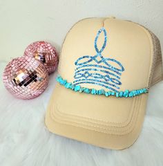 Sand Colored Trucker Hat with Turquoise Cowboy Boot Stitch Pattern Design (DTF) and Turquoise Rock Hat Charm across the rim Blue Bohemian Hat For Gift, Blue Bohemian Hat As Gift, One Size Fits Most Turquoise Hat, Blue Adjustable Trucker Hat As Gift, Adjustable Blue Trucker Hat For Gift, Blue Trucker Hat For Festival, Turquoise Cowboy Hat, Blue Trucker Cap For Festivals, Handmade Blue Mini Cap Hat