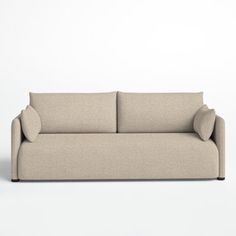 a beige couch sitting on top of a white floor