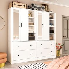 a bedroom with white furniture and pink walls