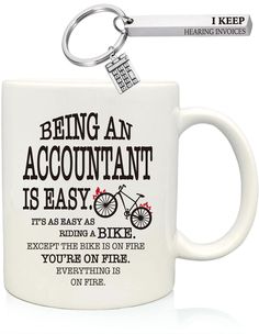 a white coffee mug with a keychain hanging from it's side and the words being an accountant is easy