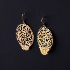 These slightly mismatched earrings were converted from antique Georgian watch cocks (circa 1780-1800) by adding 14k gold ear wires and tsavorite garnet to the gold gilt dangles. Each earring measures 1.25 inches from the top of the ear wire to bottom by 0.8 inches wide, and they are in great condition. Materials: tsavorite garnet, gold gilt, 14k. Antique Pendant Yellow Gold Earrings, Antique Yellow Gold Pendant Earrings, Antique Pierced Yellow Gold Jewelry, Antique Style Yellow Gold Plated Earrings, Elegant Green Earrings For Ceremonial Occasions, Antique Gold Victorian Drop Earrings, Victorian Yellow Gold Brass Earrings, Yellow Gold Medallion Brass Earrings, Pendant Earrings With Intricate Design In Yellow Gold