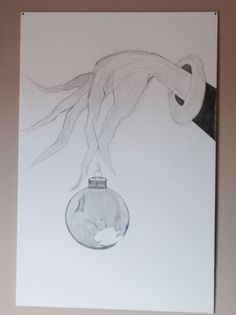 a drawing of a hand reaching for a hanging ornament