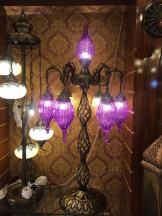 a purple chandelier sitting on top of a table next to a lamp shade