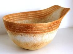 a brown and white bowl sitting on top of a table