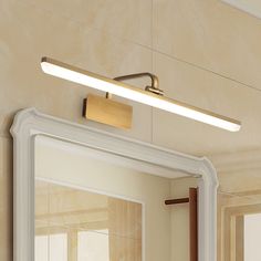 a bathroom mirror with a light above it