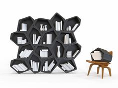 a chair and book shelf in front of a white wall with black hexagonal shelves