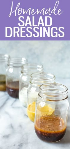 four mason jars filled with homemade salad dressings on a marble countertop and text overlay that reads homemade salad dressings