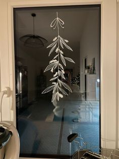 a bicycle is parked in front of a glass door with an image of a tree on it