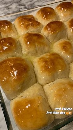 bread rolls sitting on top of a glass baking pan