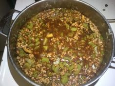 a pot filled with food sitting on top of a stove