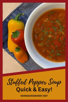 a white bowl filled with soup next to two peppers on top of a blue napkin