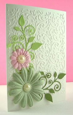 a white card with pink and green flowers on it