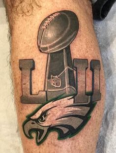 a tattoo with an eagle and football on it