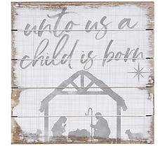 a wooden sign with the words unto us as a child is born and a nativity scene