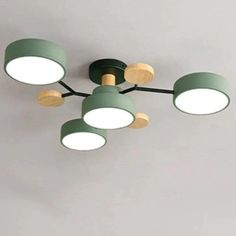 a green and white ceiling light with four lights on each side of the light fixture