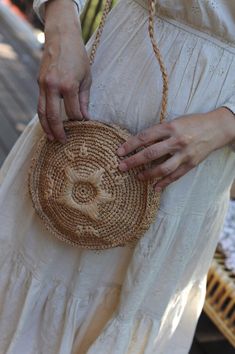 The shoulder bag to wear everywhere this Summer! Made in Raffia and adorned by a beautiful embroidered flower, it is designed by Noro Paris and handmade in crochet by fair trade artisans in Madagascar. Fabric: 100% RaffiaColor: TeaDiameter: 20 cm (7.9")Straps length: 57 cm each (22.44"), measured from the base of the strap to the shoulderDetails: braided straps, embroidered flower on the front, Main compartment zipped. Each piece is unique Artisan Crochet Bag With Adjustable Strap In Natural, Natural Crochet Bag With Adjustable Strap Artisan Style, Beige Traditional Crochet Bag, Natural Crochet Bag For Festival, Natural Crochet Festival Bag, Summer Artisan Shoulder Bag Fair Trade, Bohemian Ethically Sourced Beach Bag, Summer Artisan Fair Trade Shoulder Bag, Bohemian Ethically Sourced Bags