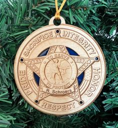 a wooden ornament hanging from a christmas tree