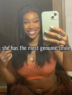 a woman taking a selfie in front of a mirror with the caption she has the most genuine smile on her face