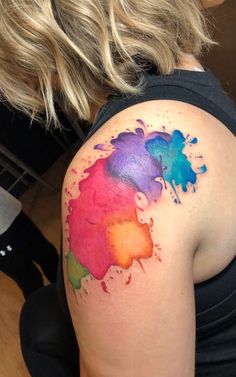 a woman with a colorful tattoo on her shoulder