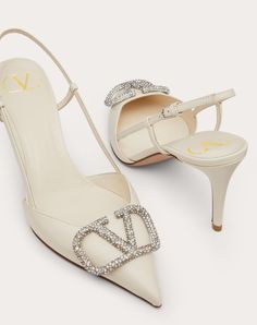 Valentino Garavani slingback pump in calfskin leather with VLogo Signature embellishment. - VLogo Signature accessory with crystal appliqués - Heel height: 80 mm / 3.1 in. - Made in Italy Luxury Crystal Embellished Slingback Pumps, Luxury Calf Leather High Heel Slingback Pumps, Luxury High Heel Calf Leather Slingback Pumps, Luxury Calf Leather Slingback Pumps For Evening, Luxury High Heel Slingback Pumps, Luxury Slingback Pumps For Wedding, Cream Calf Leather Heels For Evening, Evening Cream Calf Leather Heels, Luxury Slingback Heels For Gala