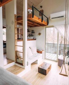 a living room filled with furniture next to a sliding glass door and wooden flooring