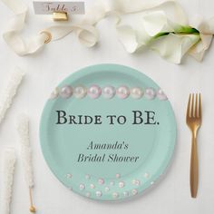 the bride to be plate has pearls on it, along with two forks and spoons