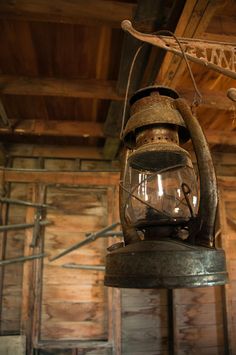 an old fashioned lantern hanging from the ceiling