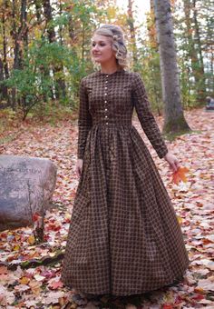 This attractive dress has a jewel neckline, front button closure and long sleeves. This dress also features our three-paneled full skirt with pockets. Hand wash or machine wash and dry gently. 100% sturdy cotton. The model is wearing boots, and a crinoline, which are priced separately. Designed and made proudly by Recollections in America! The following are approximate finished measurements and include room for ease of movement.  BustWaist (in inches) XS36.528 S39        29.5 M41        31.5 L45 Pioneer Woman Dress, Prarie Dresses, Pioneer Clothing, Prarie Dress, Pioneer Dress, Fall Outfits Ideas, Prairie Dresses, Vintage Prairie Dress, Farm Dress