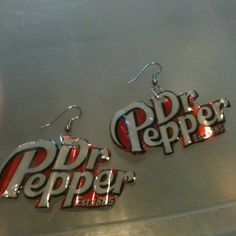 the earrings are made out of soda cans and have letters that spell pepsi on them