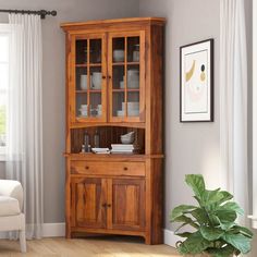 a wooden china cabinet with glass doors in a living room