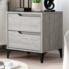 a nightstand with two drawers and a plant on top