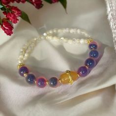 Introducing our Chinese vintage style beaded bracelet that one side is made in gradient purple color agate beads, and the other side is made in small white color agate beads. the charm represents luck and peace. It is a great calming accessory to keep for yourself or to gift for your friends! Bohemian Moonstone Beaded Bracelets With 8mm Beads, Elegant Agate Beaded Bracelet With Colorful Beads, Spiritual Agate Beaded Bracelets With Colorful Beads, Purple Agate Bracelets, Spiritual Agate Bracelets With Colorful Beads, Spiritual Agate Crystal Bracelet With Colorful Beads, Agate Crystal Bracelet With Gemstone Beads, Colorful Agate Beads Bracelets As Gift, Round Agate Bracelet With Colorful Beads