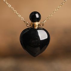 ⚫ Elevate your style and spiritual journey in one swoop with our Black Agate Crystal Perfume Bottle Necklace. This extraordinary accessory melds the elegant depth of black agate with the novelty of a refillable perfume bottle, all encased within a chic necklace. Cut from premium quality black agate, each bottle unveils an enchanting darkness, contrasted beautifully with vibrant bands and inclusions. This necklace seamlessly blends luxury with functionality, housing your most cherished scents wit Formal Black Locket Necklace, Black Agate Jewelry For Gifts, Elegant Black Keepsake Jewelry, Black Spiritual Locket Jewelry, Black Heart-shaped Necklace For Keepsake, Black Heart Necklaces For Keepsake, Black Heart Necklace For Keepsake, Black Spiritual Jewelry With Locket, Spiritual Black Locket Jewelry