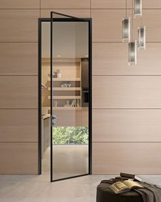 a suitcase sitting on the floor in front of a wall with wooden paneling and glass doors