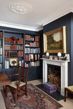 a living room filled with furniture and a fire place in front of a book shelf