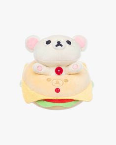 a stuffed animal is sitting on top of a hamburger